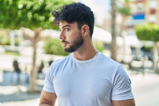 istock Young hispanic man with relaxed expression standing at street 1437883580