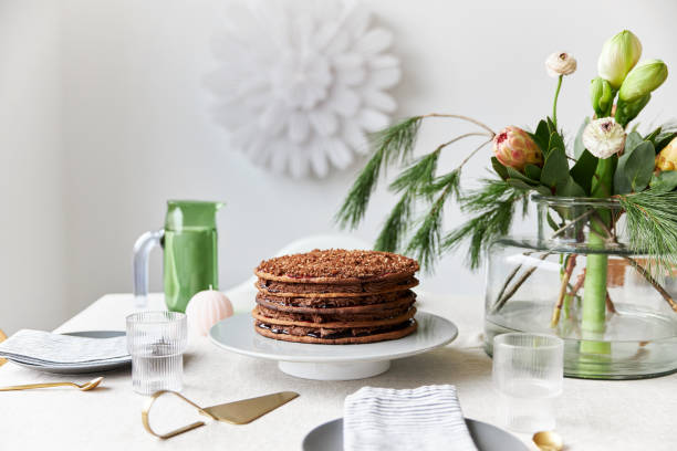 istock A gingerbread cake stands on a table decorated in a modern, Christmassy way 1437883592