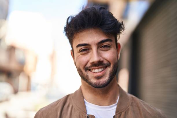 istock Young hispanic man smiling confident standing at street 1437883608