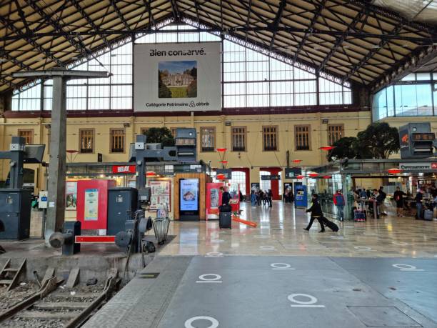 Inside Marseille-Saint-Charles station. The image shows the main hall of the railway Station with several commuters. The station has 16 tracks and gives access to a metro station.