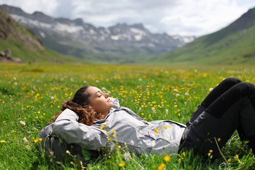 Hiker resting in a valley of a high mountain