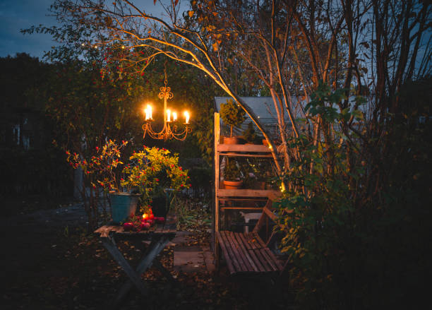 lit candle in chandelier outside in the garden