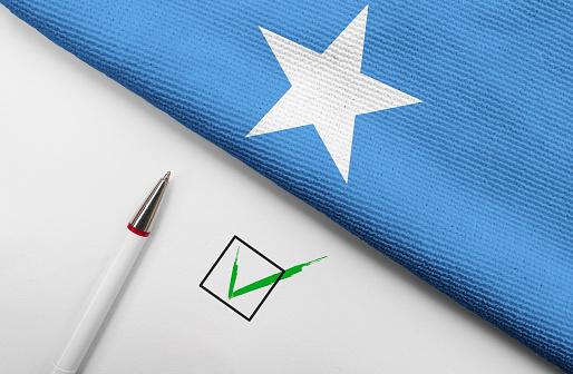 Pencil, Flag of Somalia and check mark on paper sheet