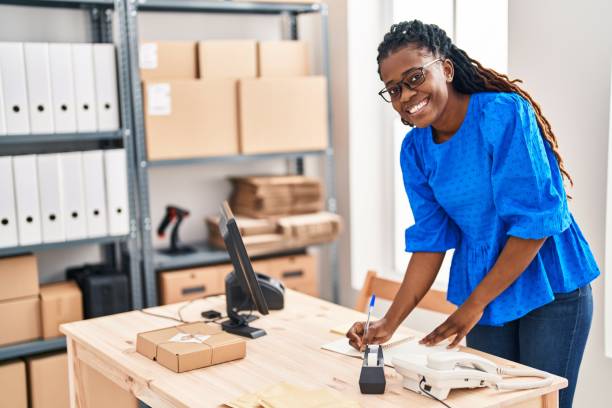 istock African american woman ecommerce business worker writing on notebook at office 1437889321