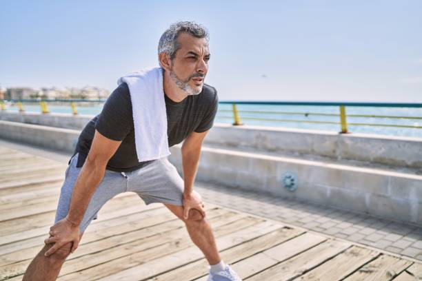 istock Middle age hispanic man wearing sportswear resting at seaside 1437894140