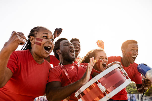 African football fans having fun cheering their favorite team - Soccer sport entertainment concept stock photo