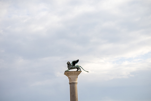 The winged lion of St. Mark standing on a pillar at St. Mark's Square