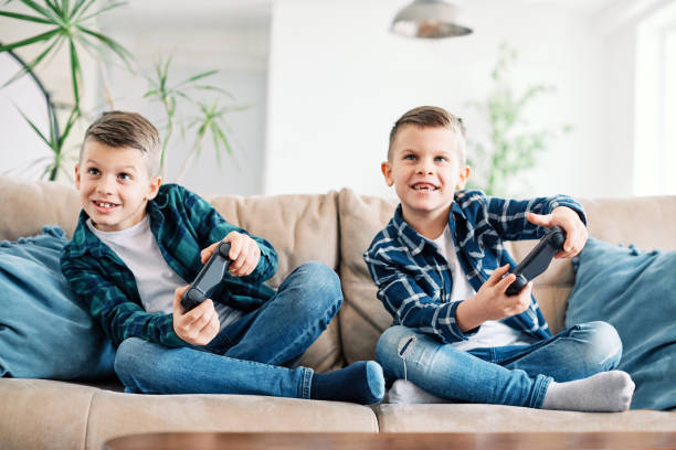 istock child brother friend having fun playing console laughing happy kid controller gaming 1437896236