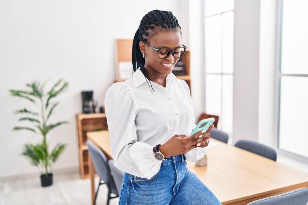 istock African american woman business worker smiling confident using smartphone at office 1437896336