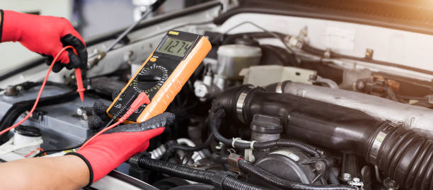 istock A technician is checking the car battery for availability. 1437896742