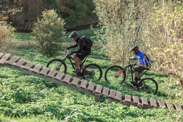 Two black mountain bikers enjoying the exercise on an outdoor biking trail