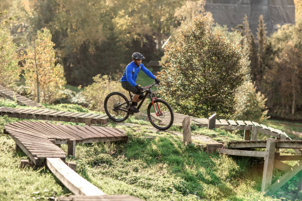 An adventurous black mountain biker alone on the trail