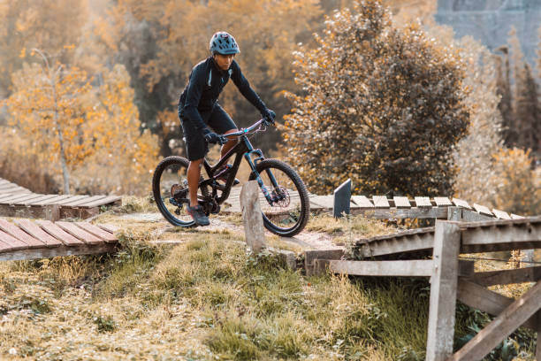 An adventurous black mountain biker alone on the trail