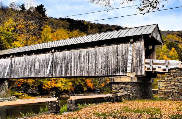 istock Rural covered bridge over calm river water 1437905441