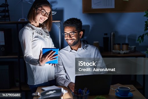 istock Man and woman business workers using laptop and touchpad at office 1437905680