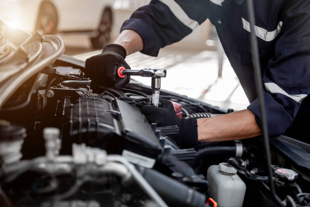 istock Car care maintenance and servicing, Close-up hand technician auto mechanic using the wrench to repairing change spare part car engine problem and insurance service support. 1437905930