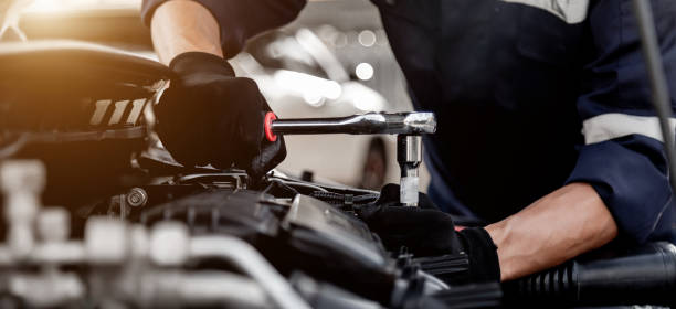 istock Car care maintenance and servicing, Close-up hand technician auto mechanic using the wrench to repairing change spare part car engine problem and insurance service support. 1437905960