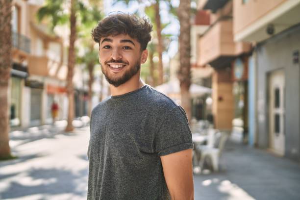 istock Young arab man smiling happy standing at the city. 1437908263
