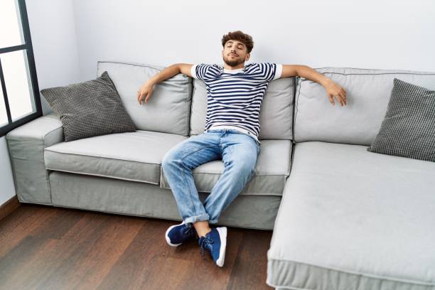 istock Young arab man smiling confident sitting on the sofa at home 1437908334