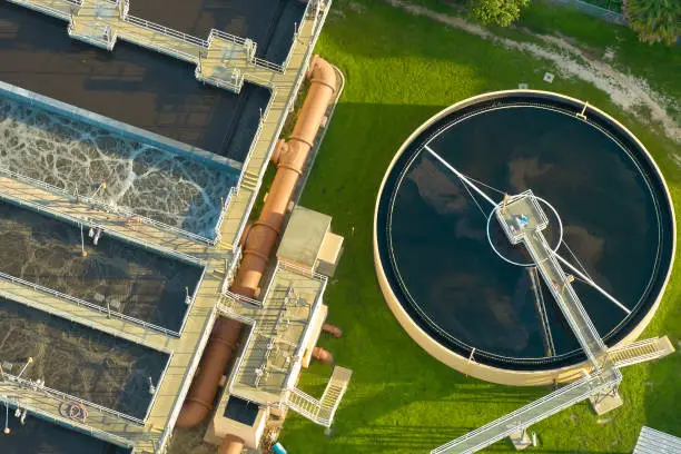 Photo of Aerial view of modern water cleaning facility at urban wastewater treatment plant. Purification process of removing undesirable chemicals, suspended solids and gases from contaminated liquid