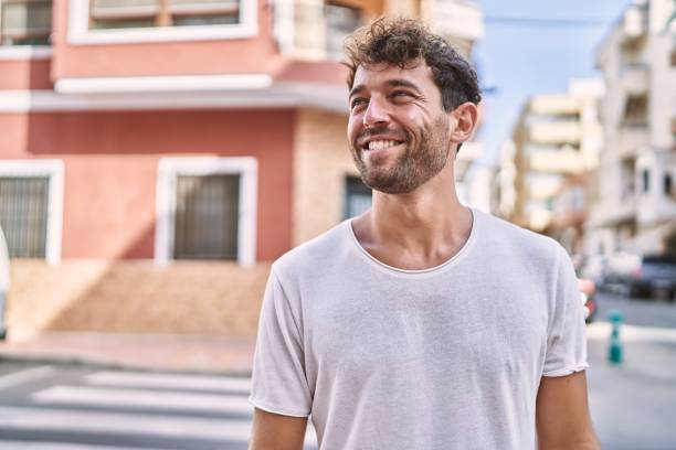 Young hispanic man smiling confident walking at street
