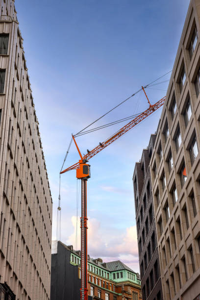 istock Building work stopped with large orange crane in city centre apartment area 1437916507