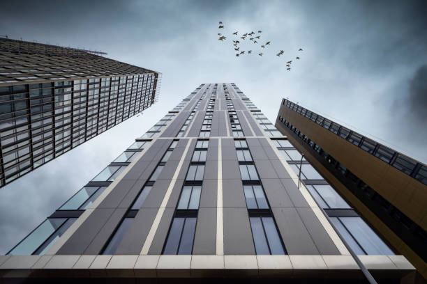 Dramatic perspective tower block modern apartment building looking up to skyline