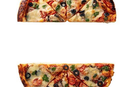 Pizza cut in half on a white background isolate, top view