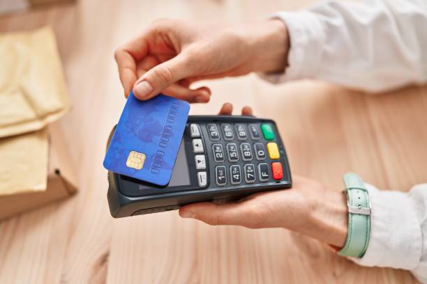 istock Young caucasian woman using credit card and data phone at office 1437919257