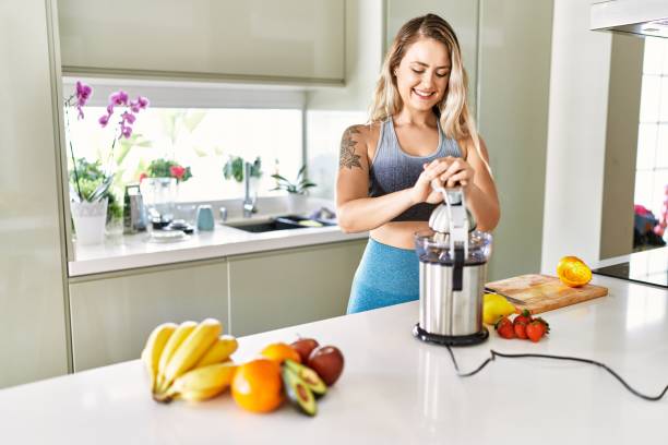 istock Young woman smiling confident using blender at kitchen 1437919745