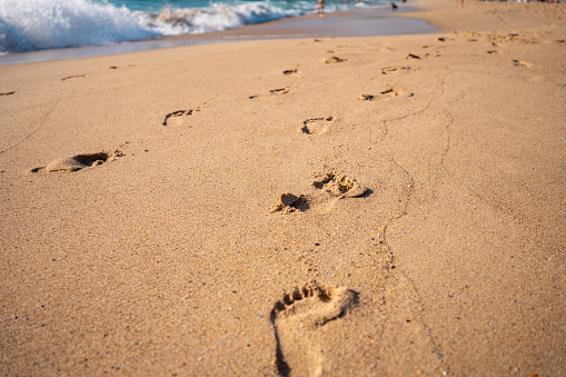 Footprints On Ocean Sandy Beach