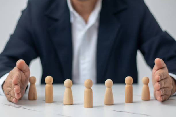 istock Executives use middle hands, male and female wooden dolls (management concept in the organization). 1437921291