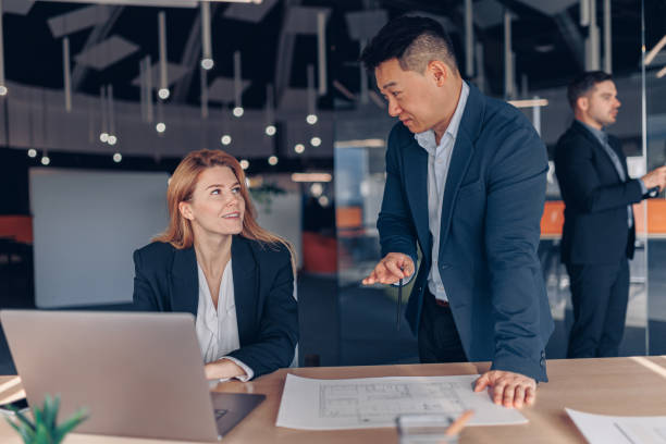 istock Two multiethnic colleagues working together on project in modern office 1437921825