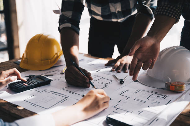 istock Architect concept, Architects working with blueprints in the office, Vintage Effect 1437923656
