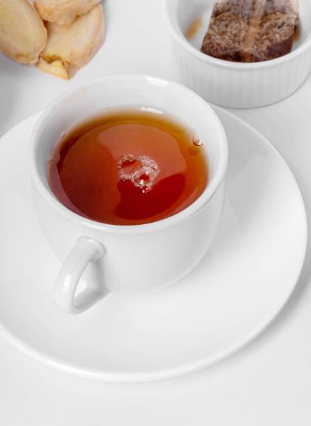 istock A cup of fresh tea with lemon and ginger. White background, isolated white. Close up. 1437924770