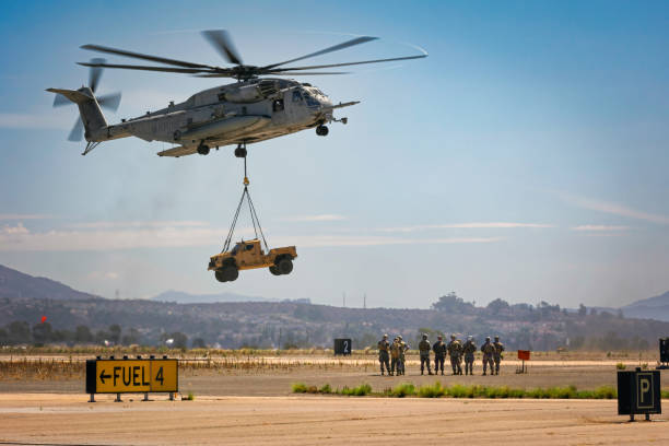 Sea Stallion Inbound 2 Miramar, California, USA - September 22, 2022: Marines watch an H-53 Sea Stallion bring a vehicle to the Marine Air-Ground Task Force demonstration rehearsal for the 2022 Miramar Airshow. miramar air show stock pictures, royalty-free photos & images