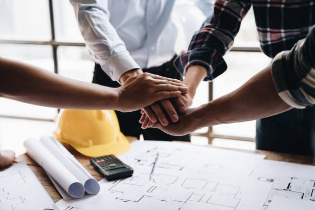 istock Businessman handshake with engineering in construction renovate building site. Engineer/architect inspection workplace for project.Teamwork construction engineer,business and architecture concept. 1437925740