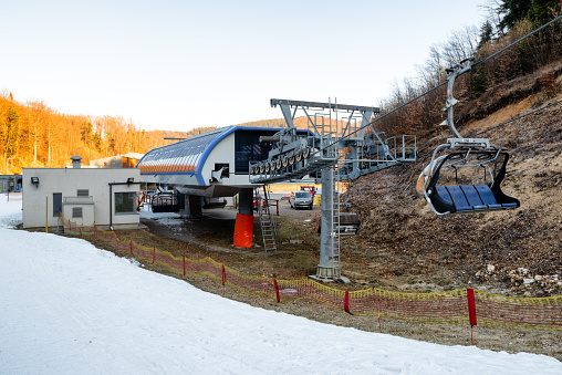 BANSKA STIAVNICA, SLOVAKIA - FEBRUARY 27, 2022: Bottom station of ski-lift chair at Salamandra resort in winter season.
