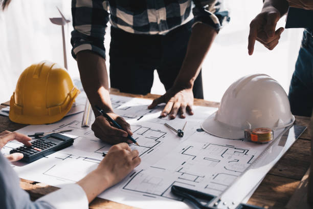 istock Architect concept, Architects working with blueprints in the office, Vintage Effect 1437926328