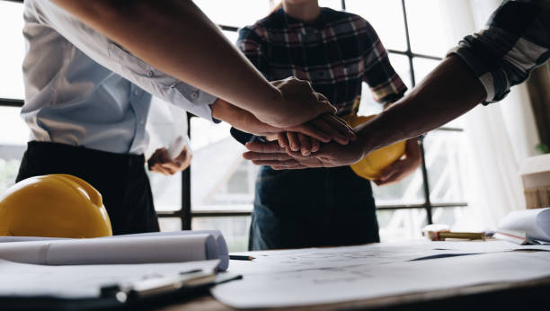 istock Businessman handshake with engineering in construction renovate building site. Engineer/architect inspection workplace for project.Teamwork construction engineer,business and architecture concept. 1437926380