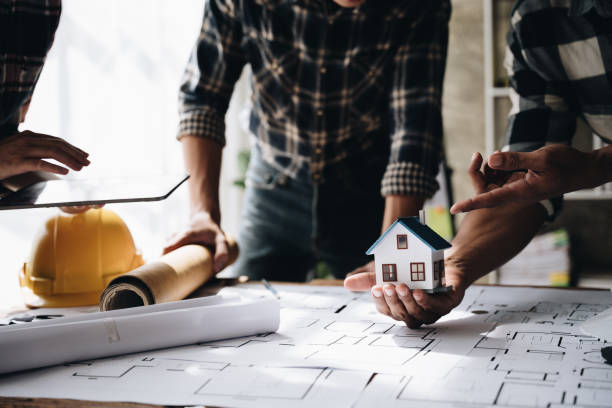 istock Confident team of engineers working together in a architect studio. 1437926576