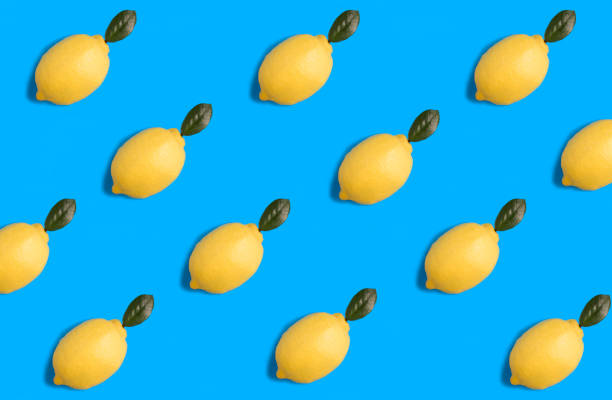 istock Lemon with green leaf on the blue background. Flat lay. Pattern. Top view. 1437927754