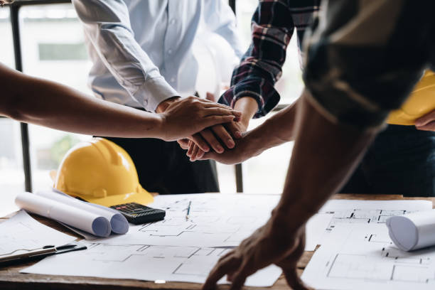 istock Businessman handshake with engineering in construction renovate building site. Engineer/architect inspection workplace for project.Teamwork construction engineer,business and architecture concept. 1437927793