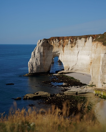 Beautiful cliff in Etretat, France with blue background of sky and ocean