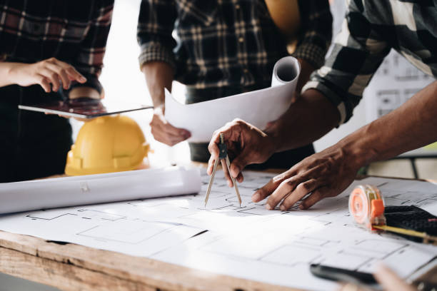 istock Confident team of engineers working together in a architect studio. 1437927979