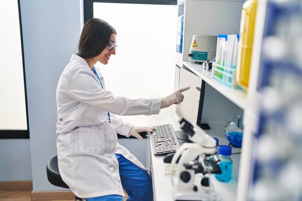 istock Young hispanic woman wearing scientist uniform working at laboratory 1437928081