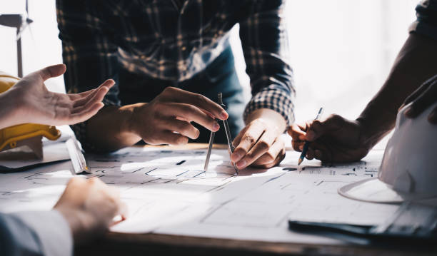 istock Architect concept, Architects working with blueprints in the office, Vintage Effect 1437928159