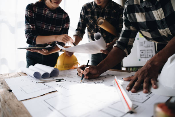 istock Confident team of engineers working together in a architect studio. 1437928230