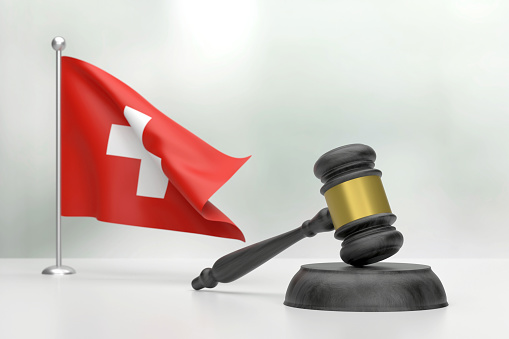 Black Wooden Gavel And Swiss Flag On White Background. Justice Concept. Justice Concept.