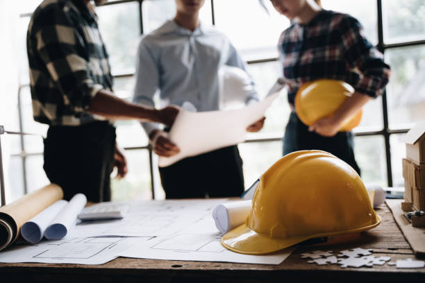 istock business engineering teamwork discussing a new building project with home model to successful business, selective focus at home model and hand. concept business engineering,architecture. 1437928378